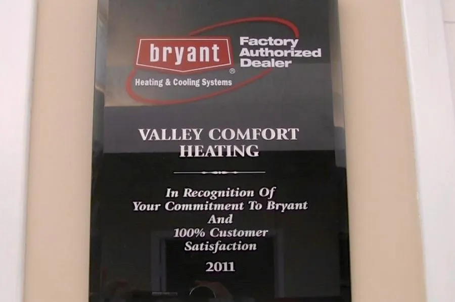  Plaque for Valley Comfort Heating from Bryant, recognizing commitment to 100% customer satisfaction, dated 2011.