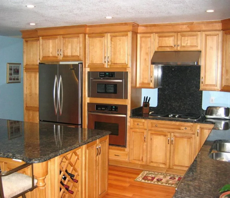 Picture of A beautifully remodeled kitchen showcases Gold Hammer Construction, Inc.'s focus on quality outcomes. The seamless integration of modern appliances and natural wood cabinetry hints at a refined, functional space crafted with care. Copyright ©2025 Diamond Certified Resource. - Gold Hammer Construction, Inc.