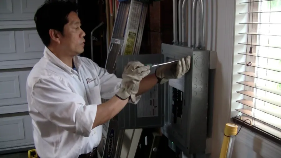 Picture of A technician from Aren Electric Co., Inc. deftly adjusts an electrical panel, symbolizing the company's commitment to quality outcomes. Known for high customer satisfaction, their expertise ensures reliable service. Copyright ©2025 Diamond Certified Resource. - Aren Electric Co., Inc.