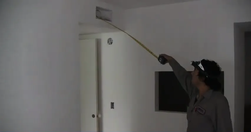 Picture of An Ortiz Heating and Air Conditioning technician meticulously measures a vent space, embodying the company's focus on quality outcomes. Their commitment to precision underscores why they earned Diamond Certified. Copyright ©2025 Diamond Certified Resource - Ortiz Heating and Air Conditioning