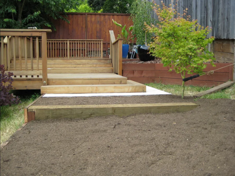Picture of Steps lead from a neatly constructed wooden deck to a freshly prepared garden area, exemplifying California Fencing's focus on quality outcomes in outdoor spaces. Copyright ©2025 Diamond Certified Resource

 - California Fencing