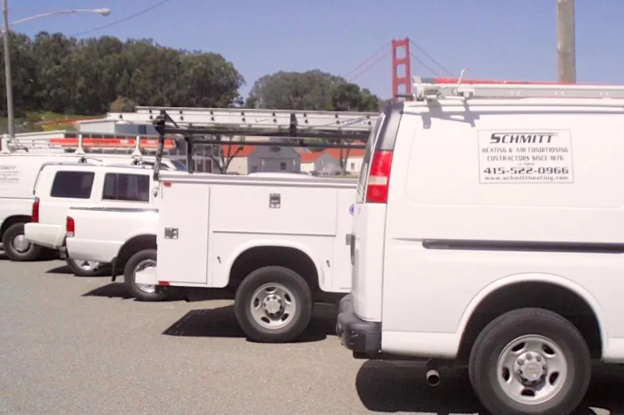 Picture of  Schmitt Heating Company, Inc. vans, equipped with ladders and tools, stand ready under the iconic bridge, symbolizing reliability and presence. The company is recognized for expertise and quality. Copyright ©2025 Diamond Certified Resource.

 - Schmitt Heating Company, Inc.