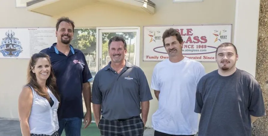 Picture of A dedicated team stands proudly in front of the Able Glass Company headquarters, embodying their commitment to quality outcomes. Known for their expertise and quality, they maintain high customer satisfaction. Copyright ©2025 Diamond Certified Resource. - Able Glass Company