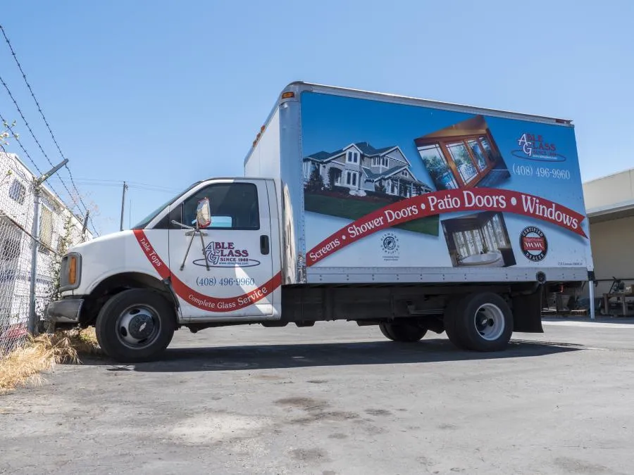 Picture of  Amidst a quiet industrial yard, Able Glass Company’s truck stands poised, symbolizing their commitment to top-rated quality and expertise in windows and doors. Copyright ©2025 Diamond Certified Resource.

 - Able Glass Company