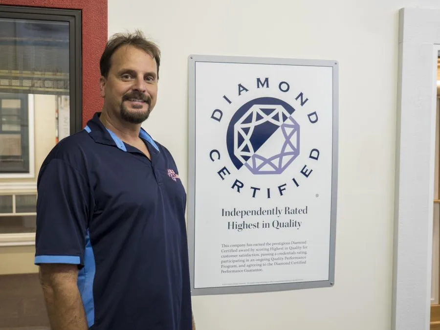 Picture of  A representative from Able Glass Company stands beside a Diamond Certified plaque, highlighting the company's recognition for achieving a Highest in Quality rating. This accolade reflects their dedication to quality outcomes and expertise in the glass industry. Copyright ©2025 Diamond Certified Resource.

 - Able Glass Company