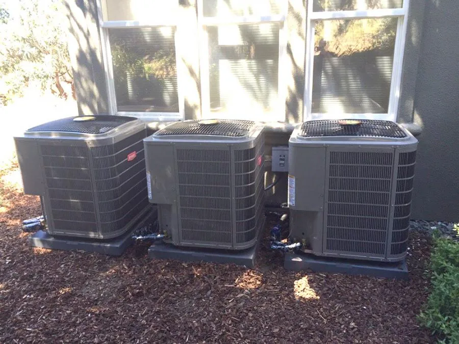 Picture of  Nestled against a sunlit exterior wall, three air conditioning units are expertly installed by Air Care Heating & Cooling, Inc., showcasing their commitment to quality outcomes. Copyright ©2025 Diamond Certified Resource.

 - Air Care Heating & Cooling, Inc.