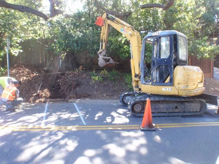 Picture of A backhoe pauses momentarily as a worker examines the progress of a roadside excavation, encapsulating Atlas Plumbing & Rooter's commitment to quality outcomes in every project. The focus on precision ensures high customer satisfaction ratings. Copyright ©2025 Diamond Certified Resource

 - Atlas Plumbing & Rooter