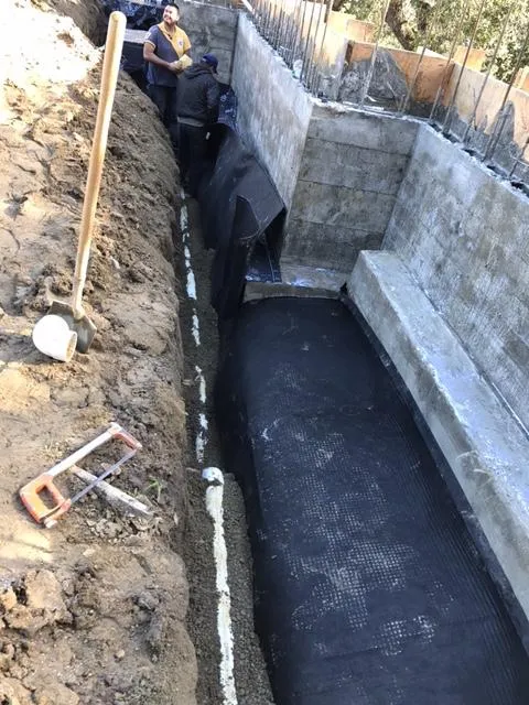 Picture of A precise arrangement unfolds as Bay Area Drainage, Inc. installs a protective membrane along a concrete structure, ensuring long-lasting stability. Recognized for expertise and quality, they excel in delivering effective drainage solutions. Copyright ©2025 Diamond Certified Resource. - Bay Area Drainage, Inc.