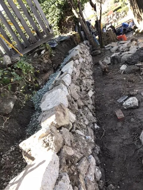 Picture of  Bay Area Drainage, Inc. meticulously constructs a sturdy retaining wall, highlighting their focus on quality outcomes. This craftsmanship ensures stability in uneven terrains. Copyright ©2025 Diamond Certified Resource.

 - Bay Area Drainage, Inc.