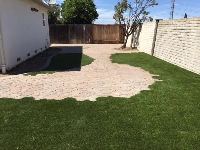 Picture of  Bay Area Drainage, Inc. transforms a plain backyard into a seamless blend of lush grass and elegant stonework, emphasizing its focus on quality outcomes. Copyright ©2025 Diamond Certified Resource.

 - Bay Area Drainage, Inc.