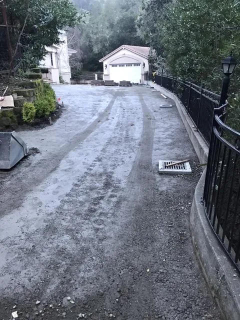 Picture of A recently graded driveway leads to a distant garage, hinting at meticulous drainage work by Bay Area Drainage, Inc., recognized for expertise and quality. Copyright ©2025 Diamond Certified Resource. - Bay Area Drainage, Inc.