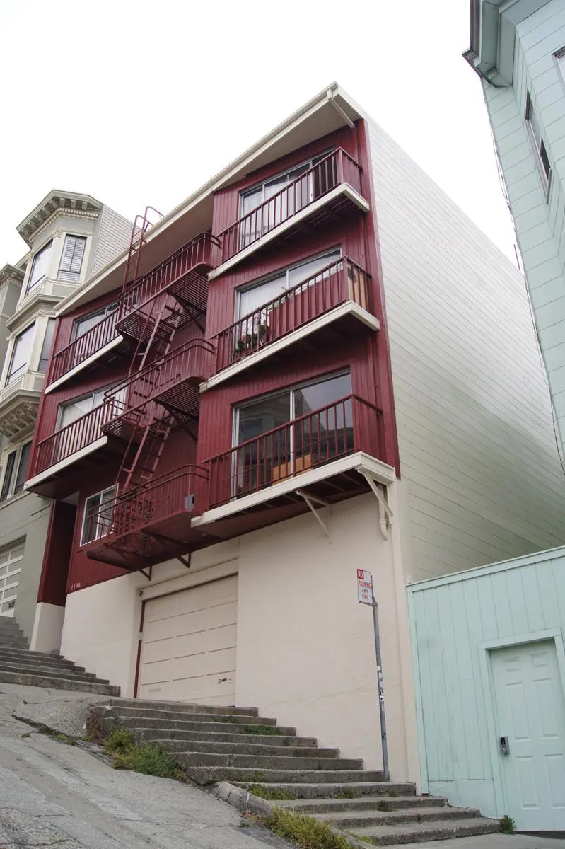 Picture of  A freshly painted apartment building stands out with its vibrant red façade against a cloudy sky, showcasing Michael Sack Painting, Inc's focus on quality outcomes. The attention to detail reflects the company's dedication to high customer satisfaction ratings. Copyright ©2025 Diamond Certified Resource.

 - Michael Sack Painting, Inc.
