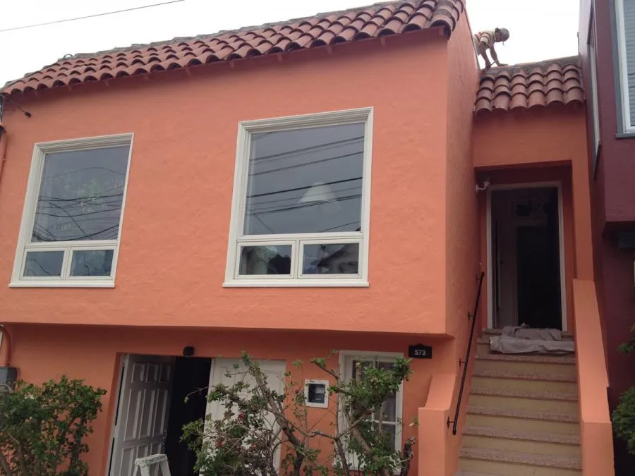 Picture of A newly painted coral house stands vibrant under a cloudy sky, showcasing the meticulous craftsmanship of Michael Sack Painting, Inc., renowned for their quality outcomes. Copyright ©2025 Diamond Certified Resource. - Michael Sack Painting, Inc.