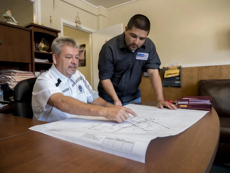 Picture of At Carol Flynn, Inc., collaboration and expertise converge as two team members discuss detailed plans, underscoring the companyâ€™s focus on quality outcomes. Recognized for its high customer satisfaction ratings, Carol Flynn, Inc. ensures precision in every project. Copyright ©2025 Diamond Certified Resource

 - Carol Flynn, Inc.