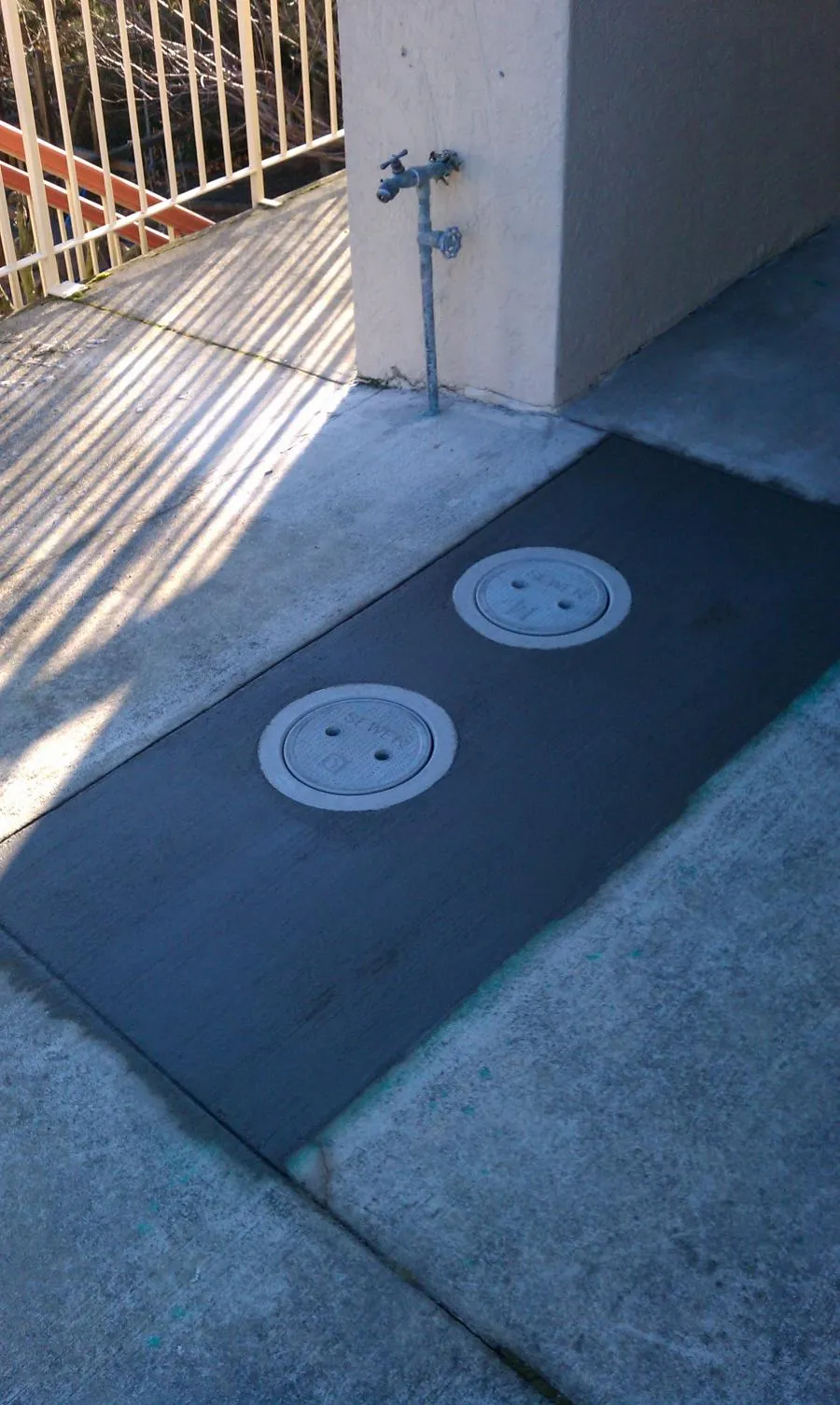 Picture of Two meticulously installed sewer cleanout covers, seamlessly integrated into the fresh concrete, reflect Superior Plumbing & Drain Cleaning Services' focus on quality outcomes. As a Diamond Certified company, they continue to consistently achieve a Highest in Quality rating. Copyright ©2025 Diamond Certified Resource - Superior Plumbing & Drain Cleaning Services