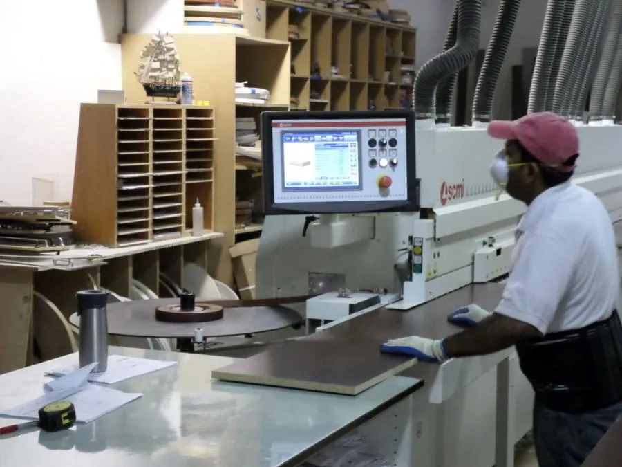 Picture of In the heart of Closet Factory's workshop, a craftsman meticulously operates advanced machinery, embodying the company's focus on quality outcomes. Their commitment to excellence is reflected in every detail. Copyright ©2025 Diamond Certified Resource

 - Closet Factory