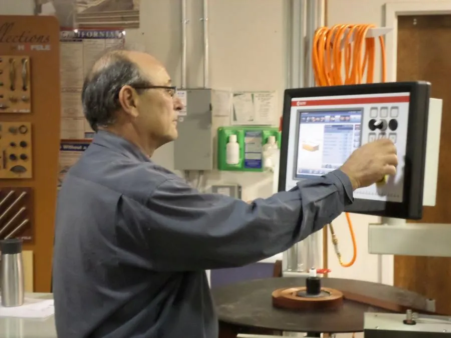 Picture of A skilled technician at Closet Factory expertly navigates a digital interface, highlighting the company's focus on quality outcomes. Recognized for expertise, Closet Factory ensures precision in every detail. Copyright ©2025 Diamond Certified Resource - Closet Factory