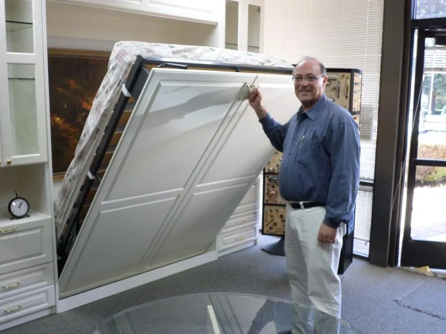 Picture of In a seamlessly integrated space, a man demonstrates the effortless transformation of a room with a foldaway bed. This innovative design by Closet Factory showcases their focus on quality outcomes. Copyright ©2025 Diamond Certified Resource

 - Closet Factory