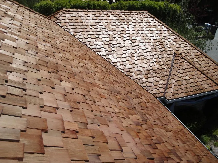 Picture of Newly installed cedar shingles create a harmonious blend of textures on a sunlit rooftop, showcasing Los Gatos Roofing's dedication to quality outcomes. Recognized for expertise and quality. Copyright ©2025 Diamond Certified Resource - Los Gatos Roofing