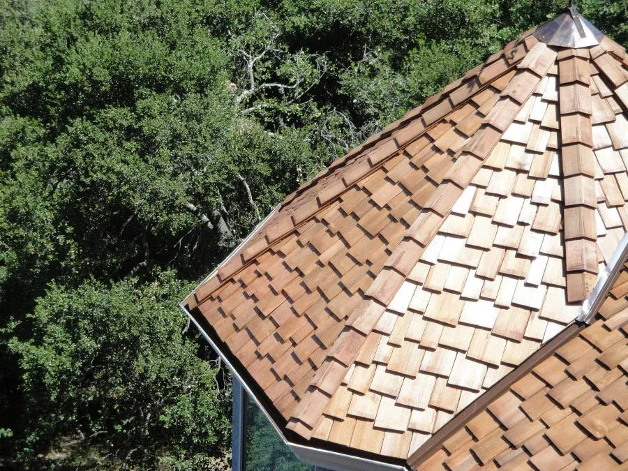 Picture of A beautifully crafted wooden shingle roof blends harmoniously with the lush greenery surrounding this home. Los Gatos Roofing, known for its quality outcomes, exemplifies attention to detail in this project. Copyright ©2025 Diamond Certified Resource - Los Gatos Roofing