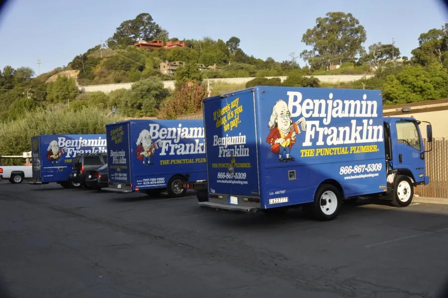 Picture of Three Benjamin Franklin Plumbing trucks, with their distinct blue and white branding, are parked in a serene setting, ready to deliver top-rated quality plumbing services. This company consistently achieves a Highest in Quality rating for its punctual and dependable expertise. Copyright ©2025 Diamond Certified Resource

 - Benjamin Franklin Plumbing