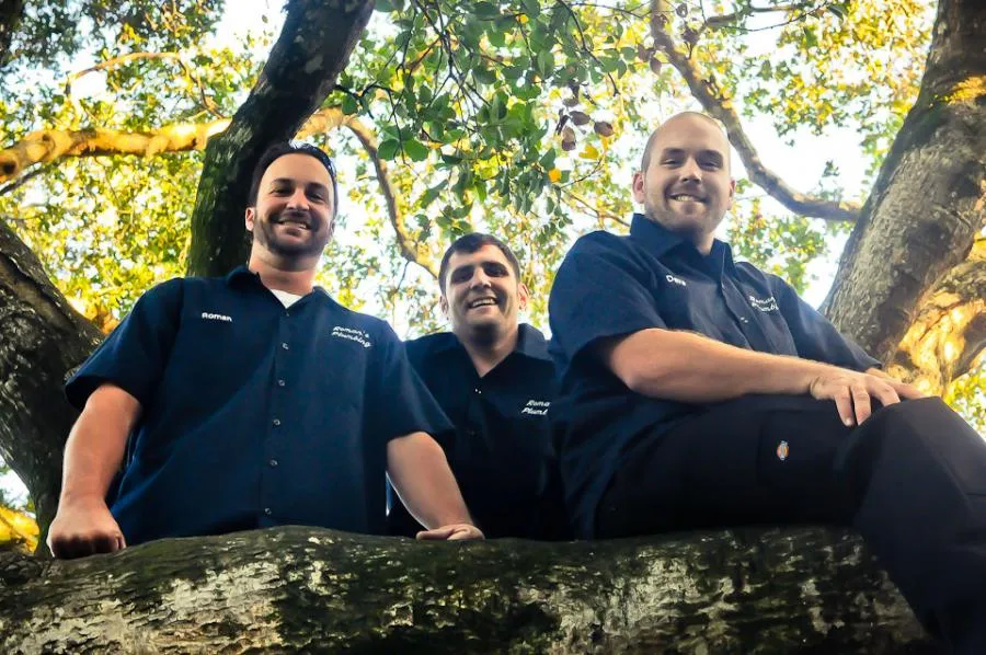 Picture of Beneath the canopy of a sprawling tree, three team members of Roman's Plumbing, Inc. share a moment of camaraderie. Their commitment to high customer satisfaction ratings is as strong as their shared vision. Copyright ©2025 Diamond Certified Resource. - Roman's Plumbing, Inc.