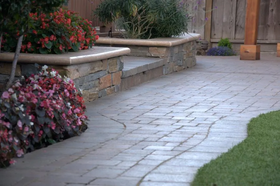 Picture of  A meticulously crafted stone pathway invites you to explore a garden of vibrant blooms, showcasing Black Diamond Paver Stones & Landscape, Inc.'s dedication to quality outcomes. Copyright ©2025 Diamond Certified Resource.

 - Black Diamond Paver Stones & Landscape, Inc.
