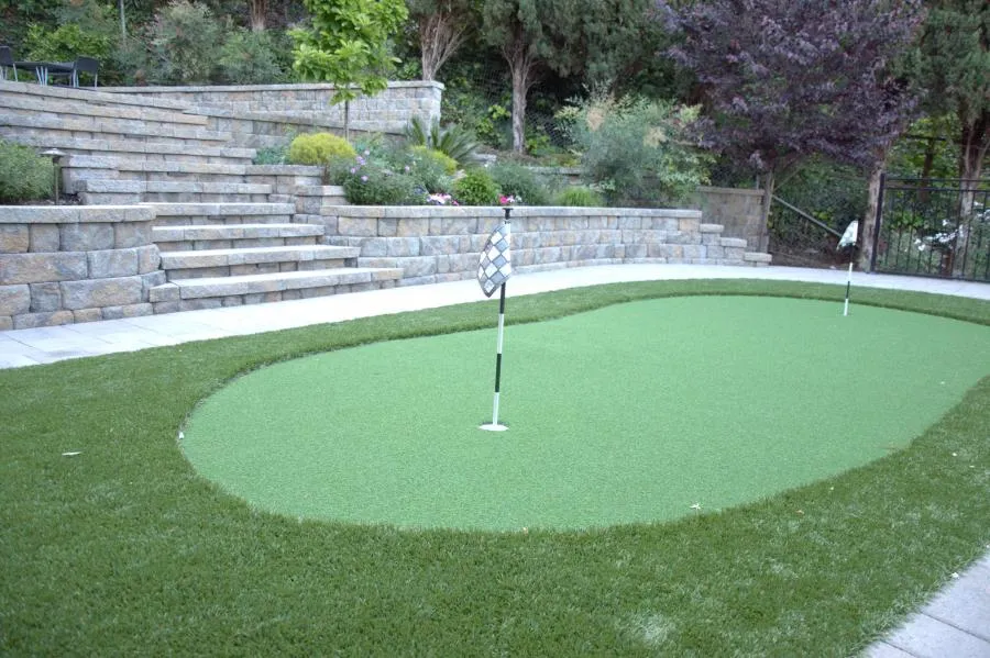 Picture of A meticulously crafted backyard putting green by Black Diamond Paver Stones & Landscape, Inc. showcases their focus on quality outcomes. This serene space invites quiet leisure amidst expertly built stone terraces. Copyright ©2025 Diamond Certified Resource. - Black Diamond Paver Stones & Landscape, Inc.