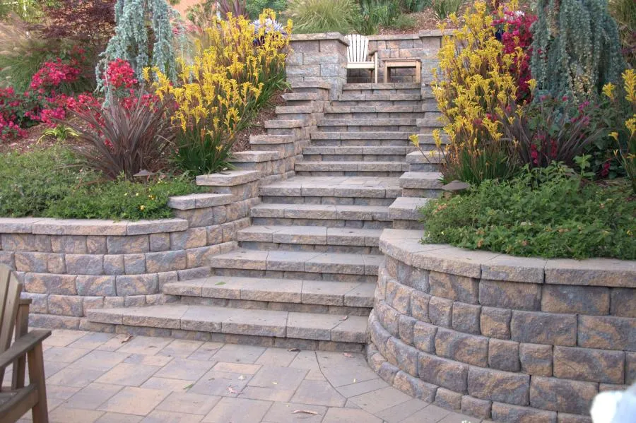 Picture of  A serene stone staircase leads to a secluded seating area, embraced by vibrant plantings. This landscape, designed by Black Diamond Paver Stones & Landscape, Inc., exemplifies their focus on quality outcomes, highlighted by a lush, harmonious environment. Copyright ©2025 Diamond Certified Resource.

 - Black Diamond Paver Stones & Landscape, Inc.