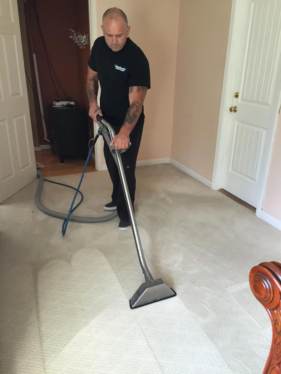 Picture of A technician from Maximum Carpet Cleaning skillfully operates a carpet cleaning machine, ensuring spotless results with precision. The company consistently achieved a Highest in Quality rating. Copyright ©2025 Diamond Certified Resource

 - Maximum Carpet Cleaning