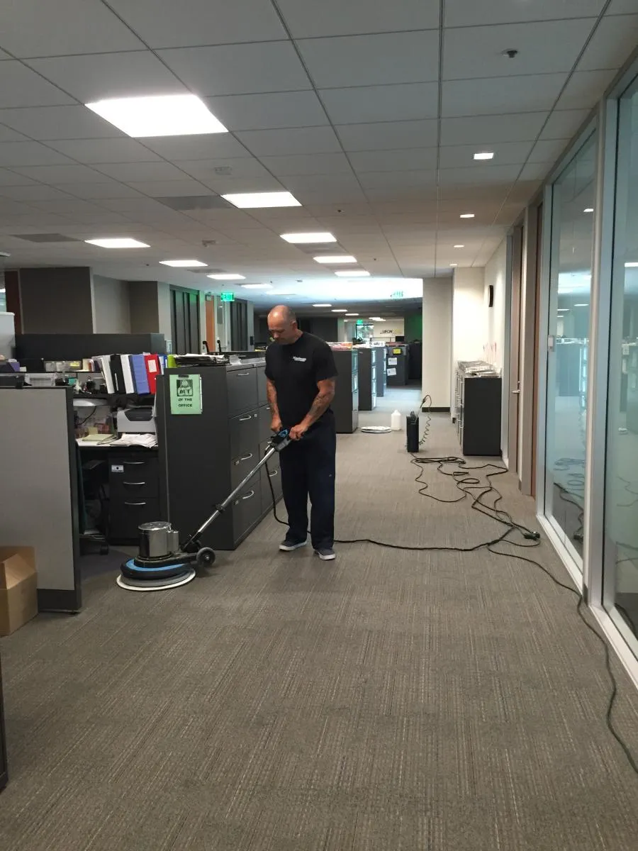 Picture of In the quiet efficiency of an office hallway, a professional from Maximum Carpet Cleaning meticulously handles a floor buffer, ensuring a spotless finish. The company, recognized for expertise and quality, consistently achieves the highest ratings. Copyright ©2025 Diamond Certified Resource

 - Maximum Carpet Cleaning