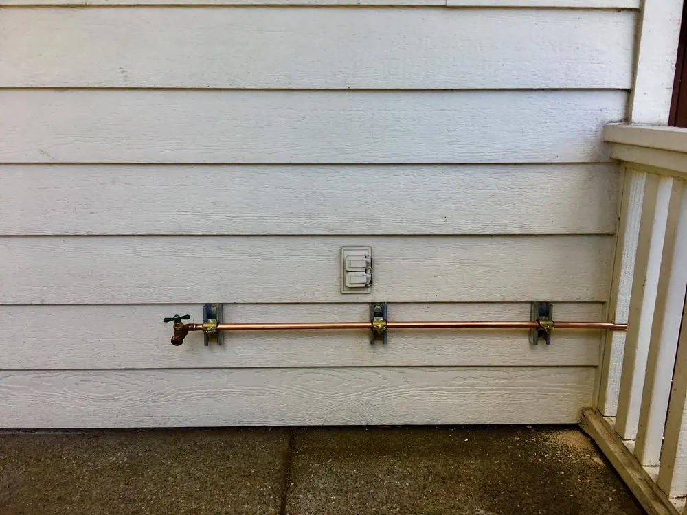 Picture of A newly installed copper pipe glistens against the exterior wall, a testament to Elite Plumbing Servicesâ€™ commitment to quality outcomes. With high customer satisfaction, they ensure lasting solutions for every home. Copyright ©2025 Diamond Certified Resource

 - Elite Plumbing Services