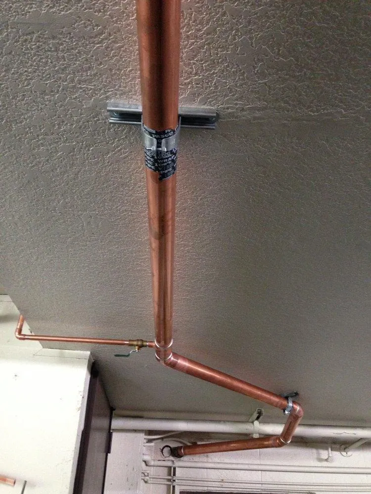 Picture of  A newly installed copper pipe seamlessly traverses the ceiling, exemplifying Gladiator Repipe, Inc.'s commitment to quality outcomes. This meticulous craftsmanship is just one reason the company consistently achieves a Highest in Quality rating. Copyright ©2025 Diamond Certified Resource.

 - Gladiator Repipe, Inc.