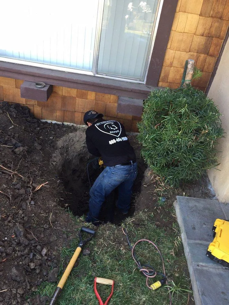 Picture of A Gladiator Repipe, Inc. technician expertly excavates a trench for plumbing repairs, embodying the company's commitment to quality outcomes. Gladiator Repipe, Inc. consistently achieves a Highest in Quality rating. Copyright ©2025 Diamond Certified Resource. - Gladiator Repipe, Inc.