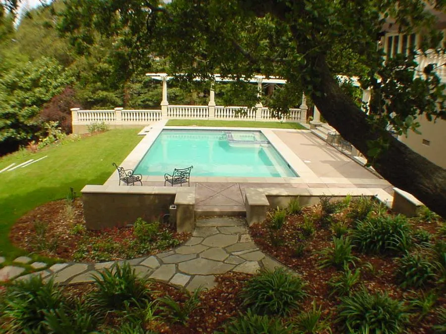 Picture of Nestled among lush greenery, a serene pool becomes the centerpiece of a beautifully landscaped backyard, showcasing Classic Pools' dedication to quality outcomes. The inviting path and carefully manicured space hint at peaceful retreat and relaxation. Classic Pools has high customer satisfaction ratings. Copyright ©2025 Diamond Certified Resource - Classic Pools
