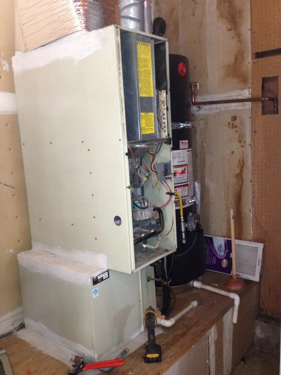 Picture of ```markdown
 A furnace stands open in a workshop, showcasing the intricacies of heating systems that Qualtech Heating & Cooling expertly handles. The company consistently achieved a Highest in Quality rating. Copyright ©2025 Diamond Certified Resource - Qualtech Heating & Cooling