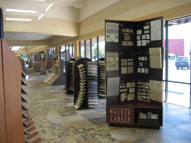 Picture of Sunlight filters through large windows, illuminating a pristine display of exquisite tile samples at The Floor Store. Known for their helpful expertise, they transform visions into reality. Copyright ©2025 Diamond Certified Resource - The Floor Store