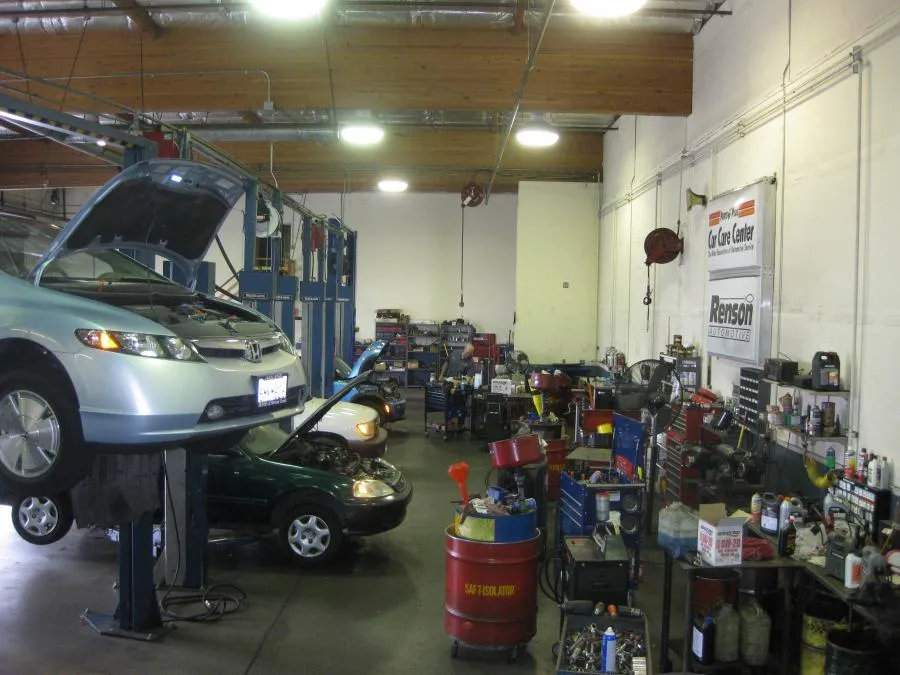 Picture of In the bustling environment of Renson Automotive, a car is lifted for service while technicians engage in meticulous repairs, highlighting the company's focus on quality outcomes. As a Diamond Certified business, Renson Automotive consistently achieves a Highest in Quality rating. Copyright ©2025 Diamond Certified Resource - Renson Automotive