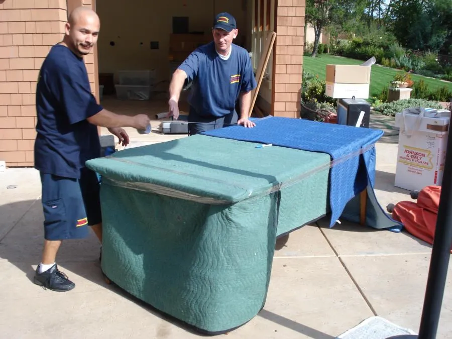 Picture of Two movers from Johnson & Daly Moving & Storage carefully wrap a piece of furniture, reflecting the companyâ€™s focus on quality outcomes. Copyright ©2025 Diamond Certified Resource

 - Johnson & Daly Moving & Storage