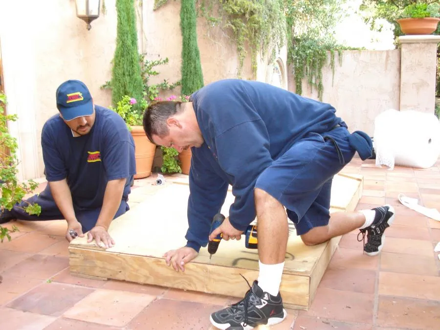 Picture of In the sunlit garden, two workers from Johnson & Daly Moving & Storage carefully assemble a wooden platform, showcasing their dedication to quality outcomes. Known for high customer satisfaction, the company consistently achieves a Highest in Quality rating. Copyright ©2025 Diamond Certified Resource

 - Johnson & Daly Moving & Storage