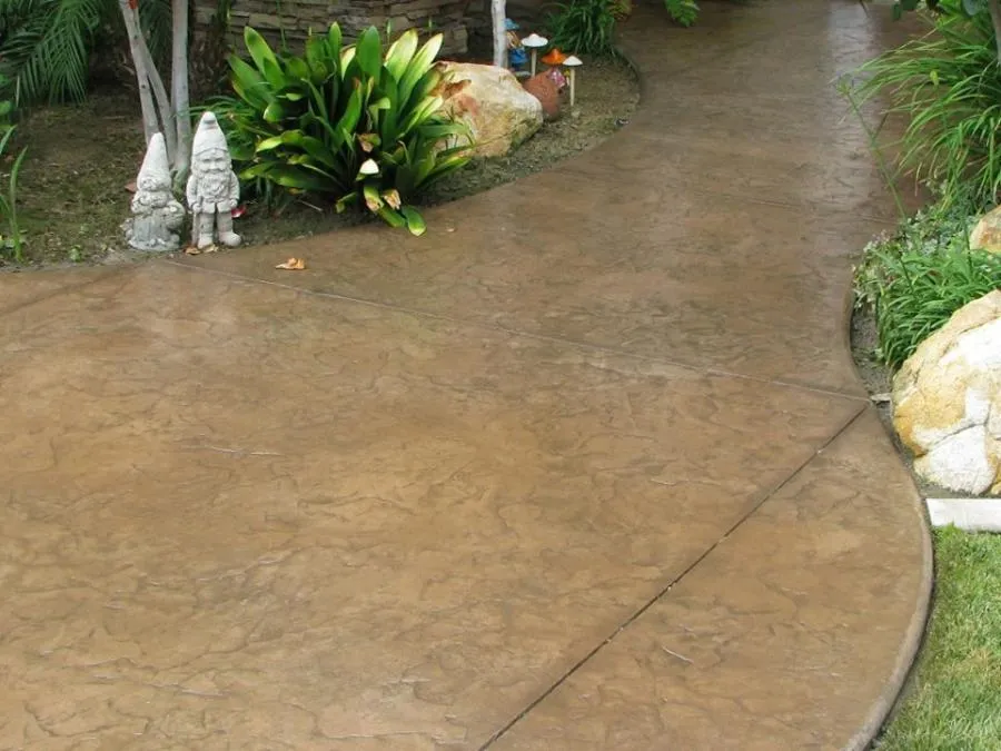 Picture of A beautifully crafted garden pathway curves gently, flanked by vibrant greenery and whimsical garden gnomes. This serene outdoor design exemplifies Kodiak Construction's focus on quality outcomes, enhancing landscapes with precision. Copyright ©2025 Diamond Certified Resource - Kodiak Construction