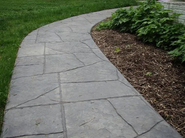 Picture of A gracefully curved stone pathway blends seamlessly with the surrounding greenery, showcasing Kodiak Construction's attention to quality outcomes. Recognized for expertise and quality, they bring landscapes to life. Copyright ©2025 Diamond Certified Resource

 - Kodiak Construction