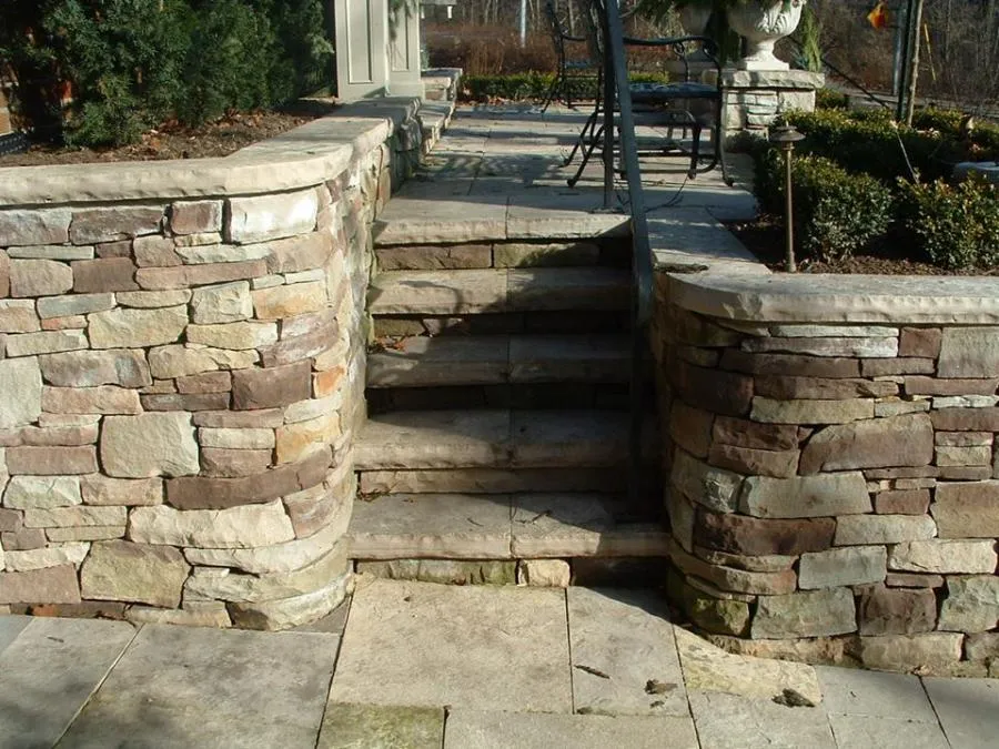 Picture of A meticulously crafted stone staircase leads to a serene patio, showcasing Kodiak Construction's focus on quality outcomes. The well-laid stones blend seamlessly with the natural surroundings, inviting relaxation. Copyright ©2025 Diamond Certified Resource

 - Kodiak Construction