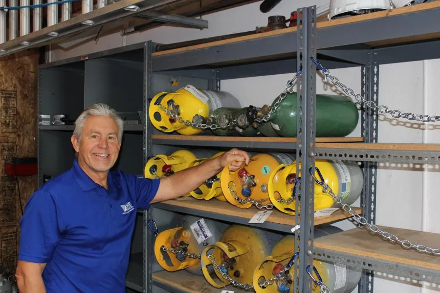 Picture of At Moore Mechanical Heating & Air Conditioning, attention to detail is paramount. A technician organizes propane tanks with precision, reflecting the companyâ€™s focus on quality outcomes. Copyright ©2025 Diamond Certified Resource - Moore Mechanical Heating & Air Conditioning