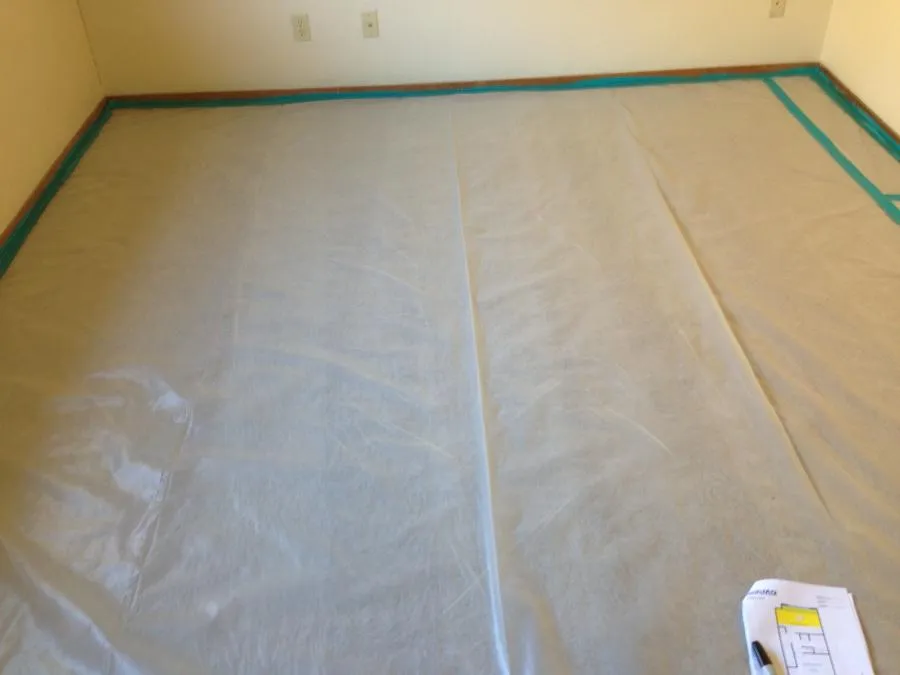 Picture of A room prepared with precision for a restoration task by NBE Property Restoration, showcasing their dedication to quality outcomes with meticulous attention to detail. The covered floor hints at an upcoming transformation, reflecting the company's focus on quality outcomes. Copyright ©2025 Diamond Certified Resource

 - NBE Property Restoration