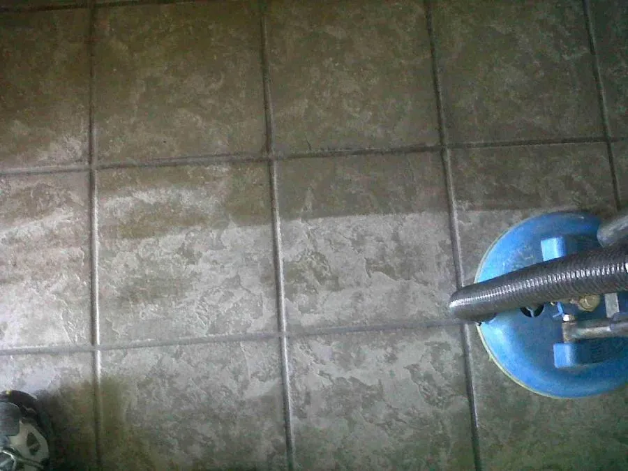 Picture of  A floor cleaning machine in action showcases North Coast Carpet Care, Inc.'s dedication to detail, revealing a stark contrast between cleaned and uncleaned tiles. Known for high customer satisfaction, the company’s expertise brings surfaces back to life. Copyright ©2025 Diamond Certified Resource. 

 - North Coast Carpet Care, Inc.