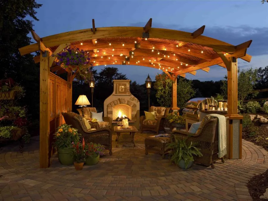 Picture of  Under a wooden pergola adorned with string lights, cozy wicker seats encircle a glowing fireplace, inviting leisurely evening gatherings. Black Diamond Paver Stones & Landscape, Inc. creates serene outdoor retreats, focusing on quality outcomes. Copyright ©2025 Diamond Certified Resource.

 - Black Diamond Paver Stones & Landscape, Inc.