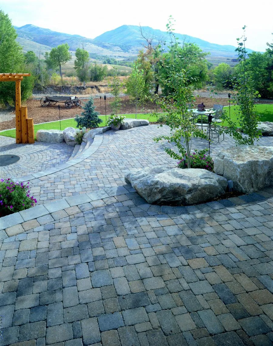 Picture of Amidst the serene landscape, a beautifully crafted stone patio invites relaxation and reflection. Black Diamond Paver Stones & Landscape, Inc. brings quality outcomes to life with this elegant design, consistently achieving a Highest in Quality rating. Copyright ©2025 Diamond Certified Resource. - Black Diamond Paver Stones & Landscape, Inc.