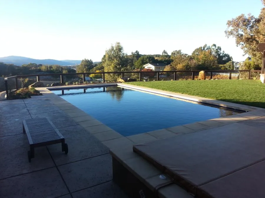 Picture of In the serene setting of a landscaped backyard, Classic Pools masters the harmony between nature and craftsmanship. This exquisite pool reflects the company's focus on quality outcomes, enhancing leisure with elegance. Copyright ©2025 Diamond Certified Resource - Classic Pools