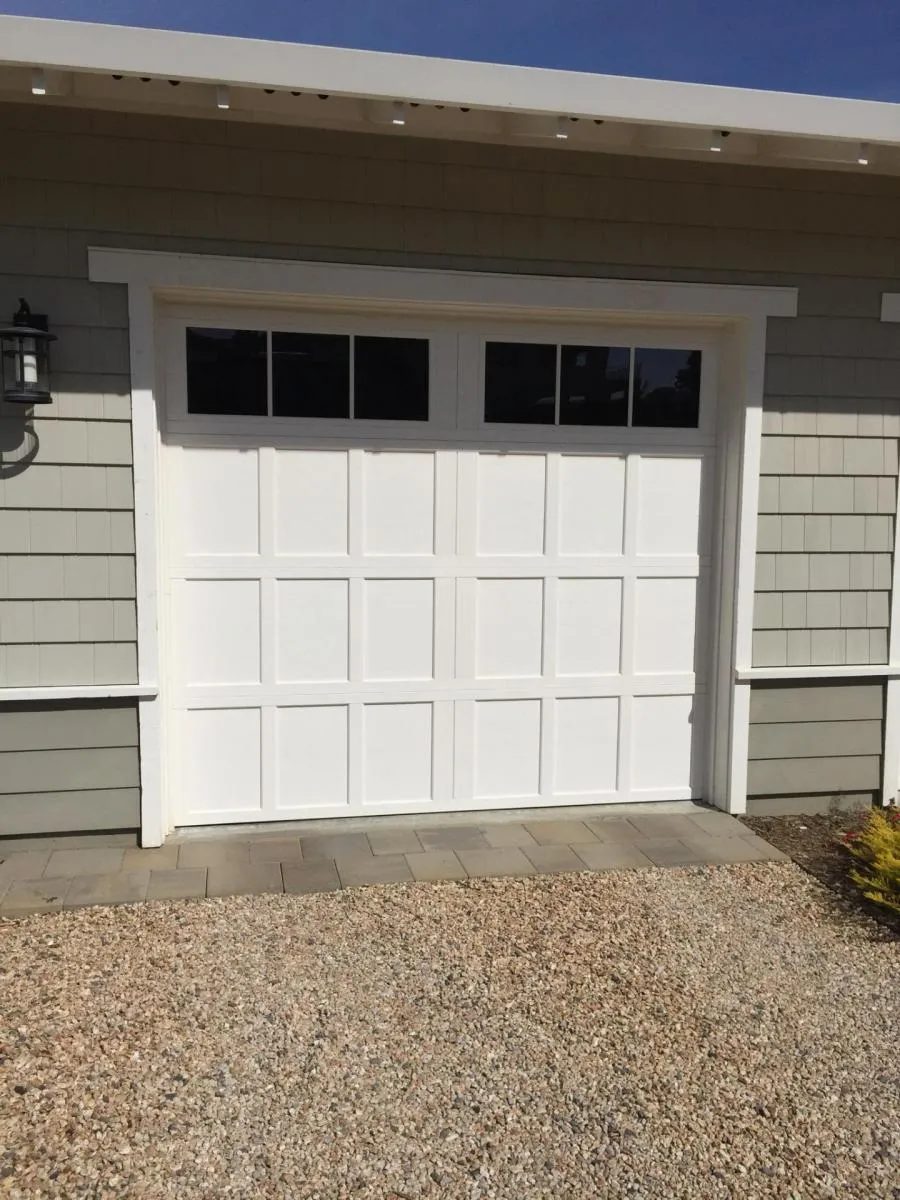 Picture of A pristine white garage door stands as a testament to R & P Garage Doors' commitment to excellence, highlighting their focus on quality outcomes. The craftsmanship is seamlessly integrated with the home's facade. Copyright ©2025 Diamond Certified Resource

 - R & P Garage Doors